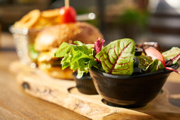 Cheeseburger with french fries on the wooden table