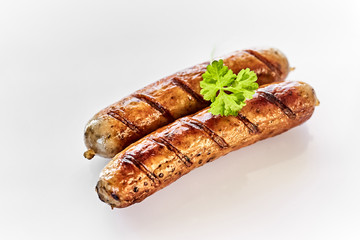 Close-up view of two grilled sausages with parsley