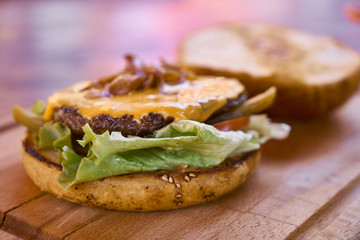 Delicious cheeseburger on the wooden table