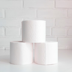 Stack of toilet paper rolls. Concept of body care, disposables, paper hygienic products.