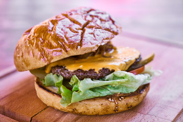 Delicious cheeseburger on the wooden table