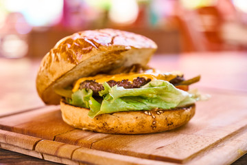 Delicious cheeseburger on the wooden table