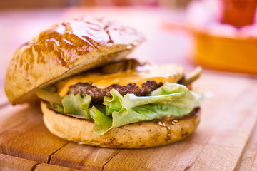 Delicious cheeseburger on the wooden table