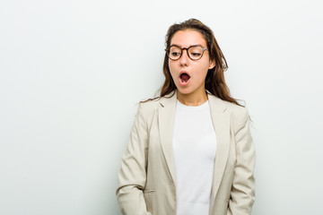 Young european business woman being shocked because of something she has seen.