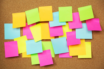 collection of colorful variety post it. paper note reminder sticky notes pad on cork bulletin...