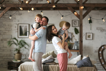 Caucasian family, parents holding brothers boys