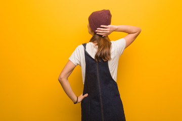 Young hipster woman from behind thinking about something
