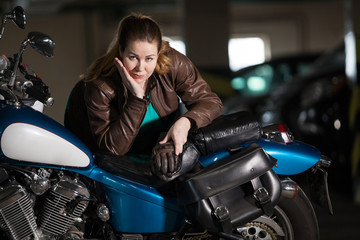 Fototapeta na wymiar Beautiful motorcycle brunette woman with a classic motorcycle, brown lather jacket