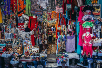 Clothes, scarfs and souvenirs for sale on Arab baazar located inside the walls of the Old City of Jerusalem, Israel