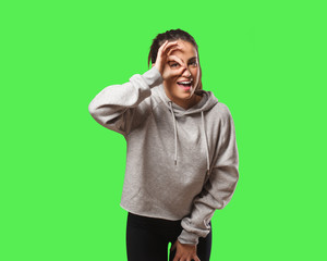 Young fitness woman confident doing ok gesture on eye