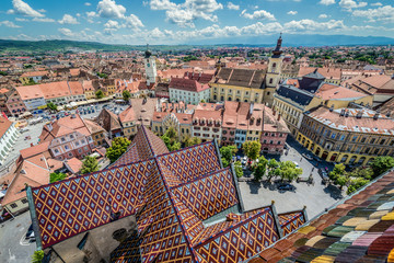 Holy Trinity Church and Council Tower in Sibiu city, view from the bell tower of St Mary Cathedral, Romania - obrazy, fototapety, plakaty
