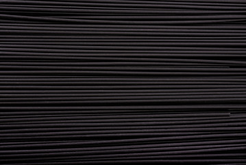 Fototapeta premium Black pasta background. Black spaghetti with squid ink, background. Pasta with black cuttlefish ink.