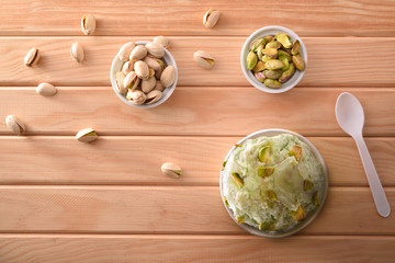 Pistachios ice cream cup decorated with pistachio chunks top