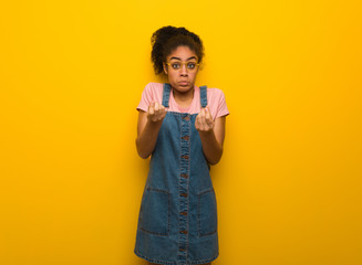 Young black african american girl with blue eyes doing a gesture of need