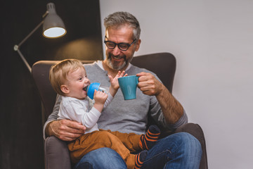 granddad and his grandson having fun at home