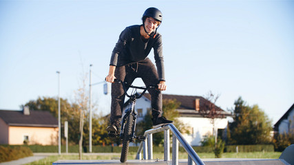 Fototapeta na wymiar Guy on a road stunt bicycle smiling