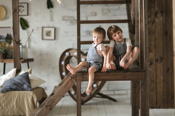 Boys play on staircase in large studio apartment