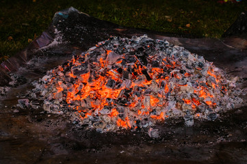 a pile of glowing coals at night