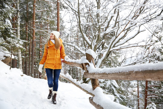 Beautiful woman in winter forest - Powered by Adobe