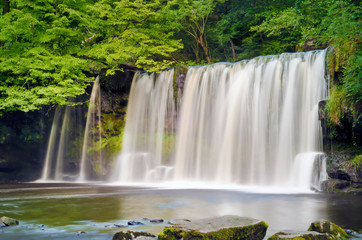 Wide waterfall in forest setting