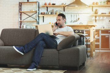 Handsome mature man working at home