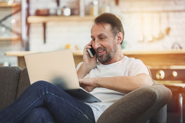 Handsome mature man working at home