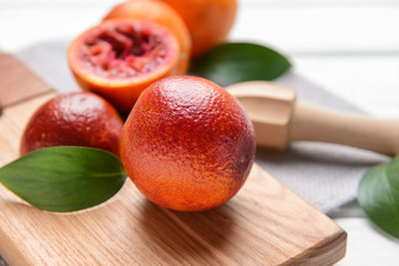 Fresh blood oranges on cutting board