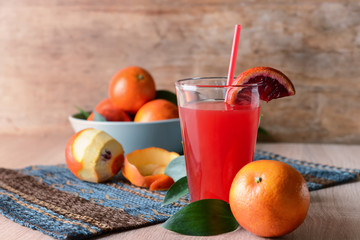Glass of fresh blood orange juice on wooden table