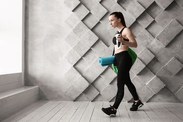 Fototapeta na wymiar Sporty woman with bag in gym