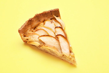 Piece of tasty apple pie on color background