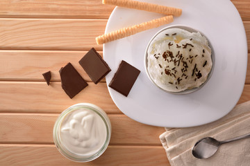 Cream and choco ice cream cup decorated with chips top