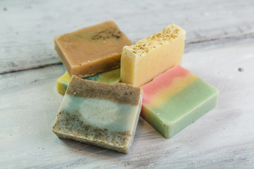 natural handmade soaps on white wooden background
