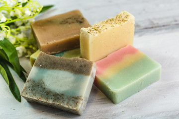 natural handmade soaps on white wooden background