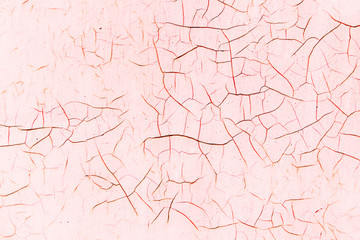 Cracked surface, background with cracks pink color