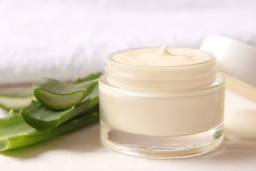 cream with aloe vera on a light background. Aloe vera skin care. Moisturizing and skin care.