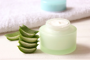 cream with aloe vera on a light background. Aloe vera skin care. Moisturizing and skin care.