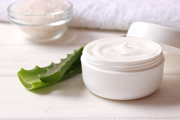 Fototapeta na wymiar cream with aloe vera on a light background. Aloe vera skin care. Moisturizing and skin care.