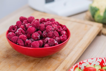 Frozen fresh raspberries on a plate.