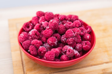 Frozen fresh raspberries on a plate.