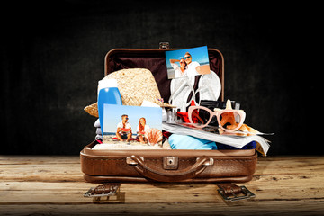 Summer suitcase and dark background of free space for your decoration. 