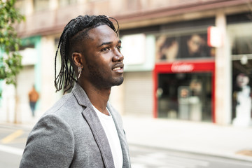 Fototapeta premium Portrait handsome african american man on the street with happy expression