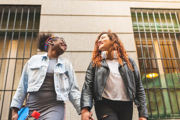 Two Teenage Latin Girls Walking Together in the Street.
