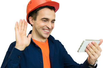 Builder with protective helmet on his head, talking on the phone, video call, smiling, isolated,...