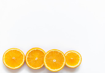 Slices of orange on a white background. Fruit with vitamin C against colds. Exotic tropical fruit for juice. Orange food. Meals for vegans.Slices of orange on a white background. Fruit with vitamin C 