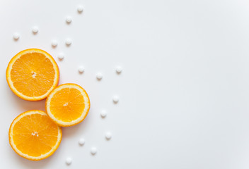 Slices of orange on a white background. Fruit with vitamin C against colds. Exotic tropical fruit for juice. Orange food. Meals for vegans.Slices of orange on a white background. Fruit with vitamin C 