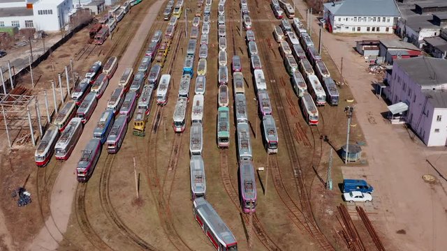 Aerial view of tram depo with many old trams.