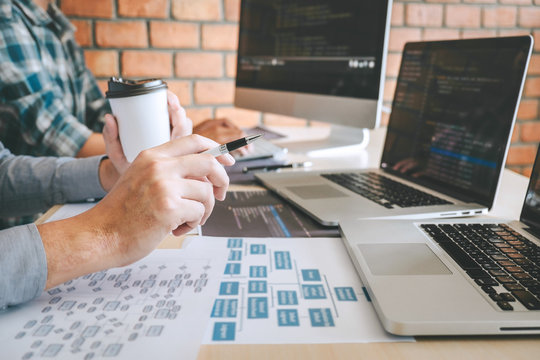 Professional Developer programmer cooperation meeting and brainstorming and programming in website working a software outsourcing and coding technology, writing codes and database