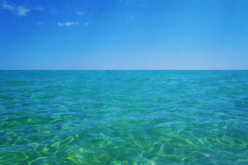 Transparent clean sunny ocean sea water waves for background and texture.