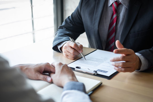 Employer or recruiter holding reading a resume during about colloquy his profile of candidate, employer in suit is conducting a job interview, manager resource employment and recruitment concept
