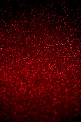 Abstract red glitter confetti sparkles on black background. Holiday background. Christmas concept. 